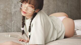 Yuna Tamago with glasses and pigtails rides a dildo